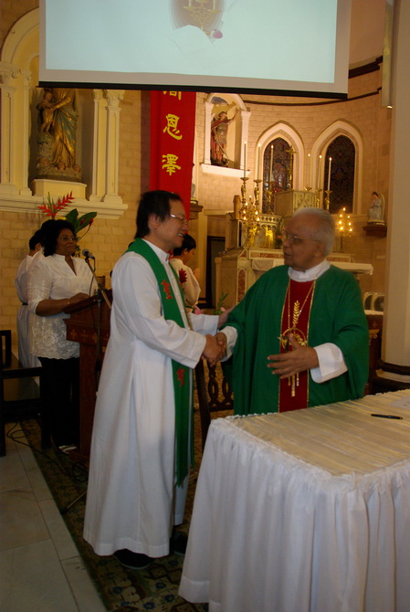 Monsignor and Bishop shake hands