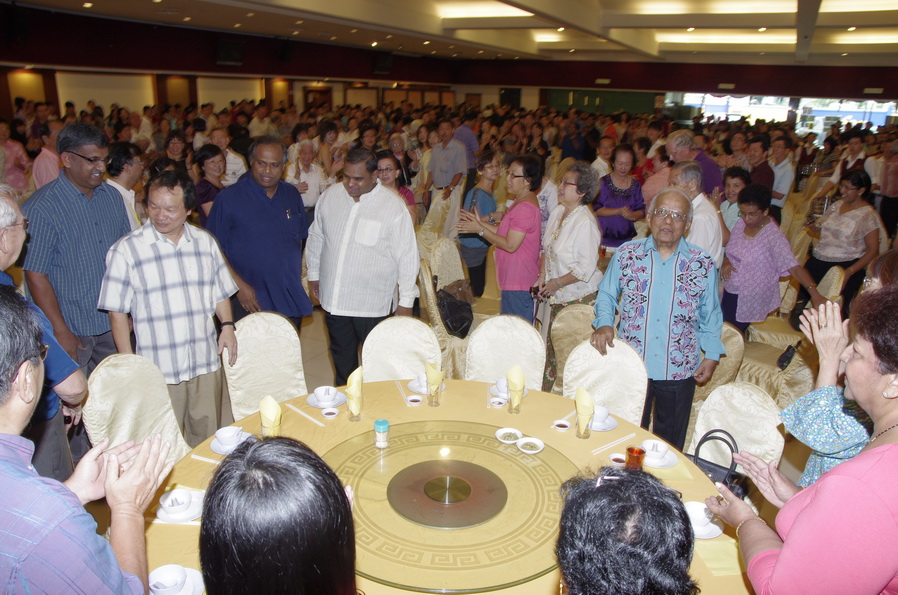 Bishop and Fr Liew being welcomed into restaurant