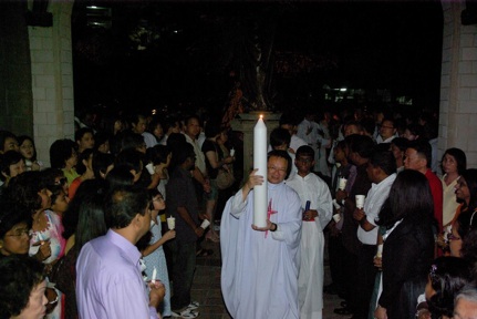 Fr Liew and Easter candle