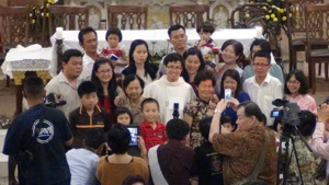 Fr Anthony Liew surrounded by family and friends after mass