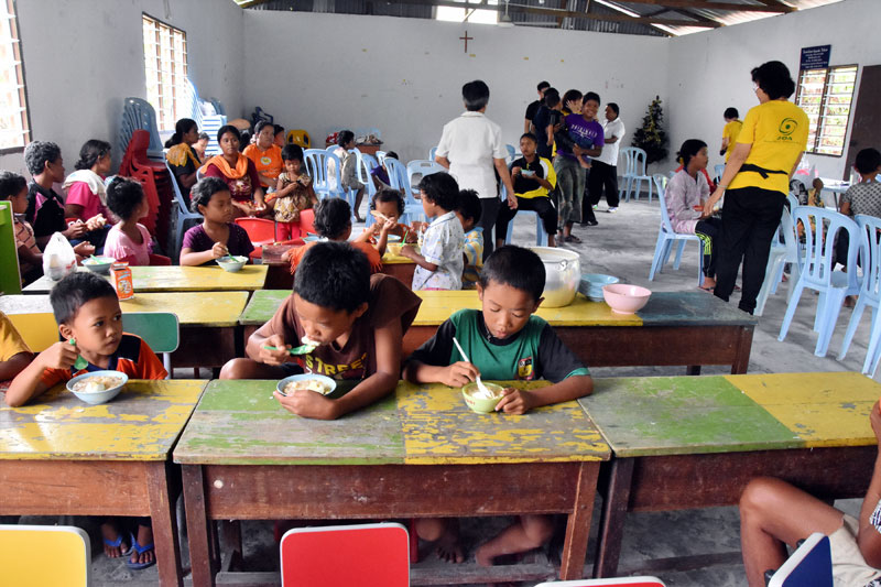 Children enjoying their lunch of fortified rice porridge