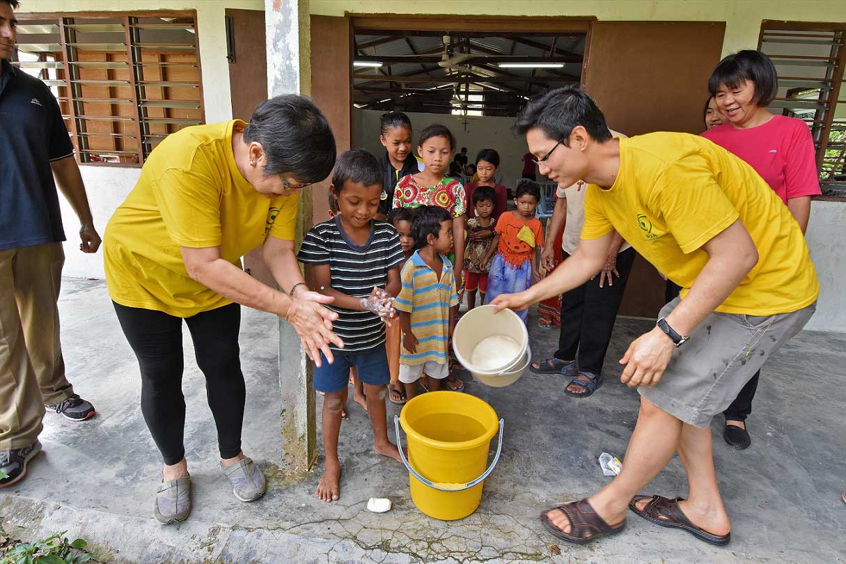 Teaching children to wash hands at Kg Sinju