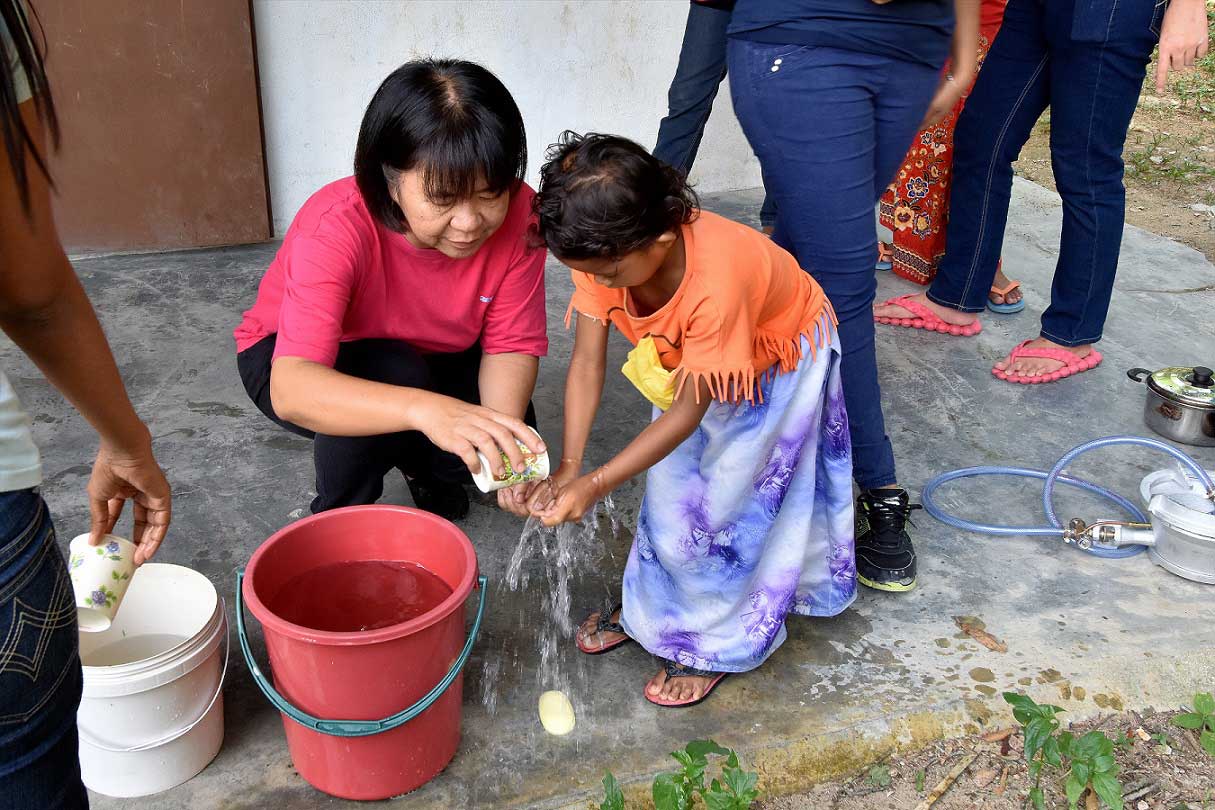 Teaching children to wash hands at Kg Sinju