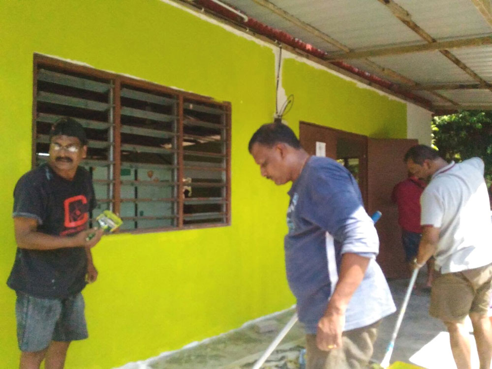 SSVP members painting exterior of chapel cum learning centre