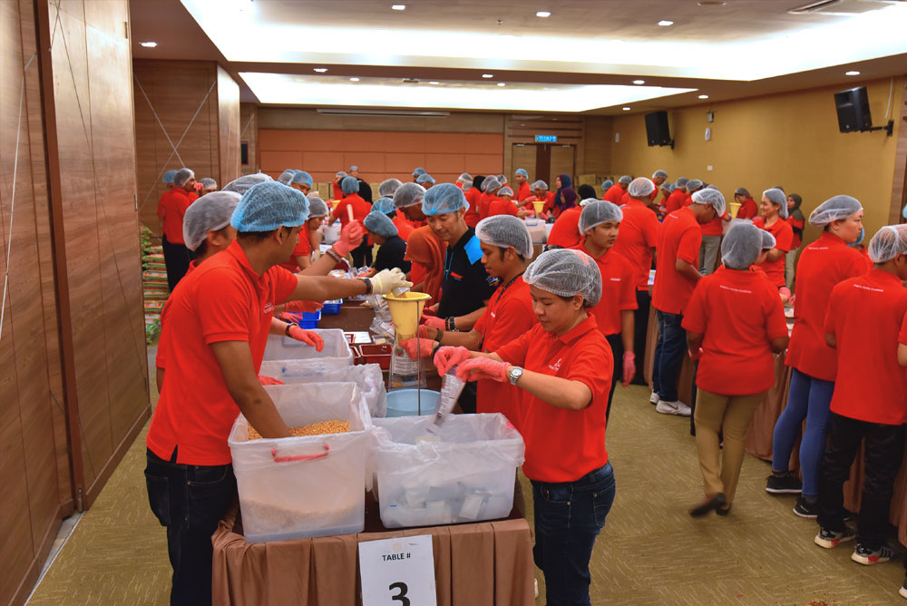 Sunway employees packing the fortified rice