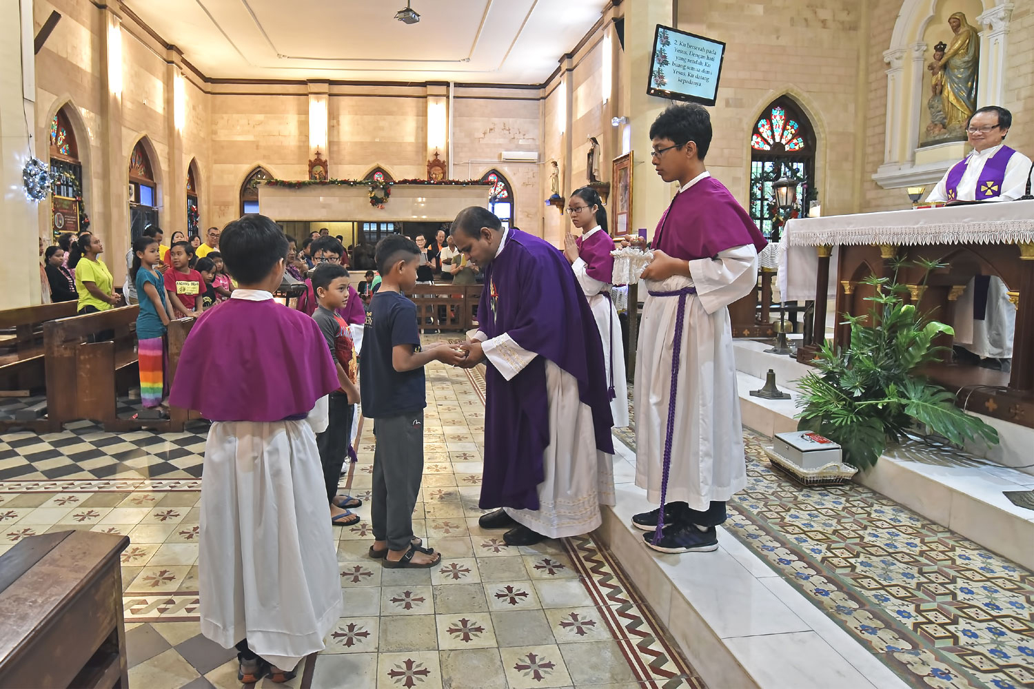 Orang asli children presenting offering during mass in BM